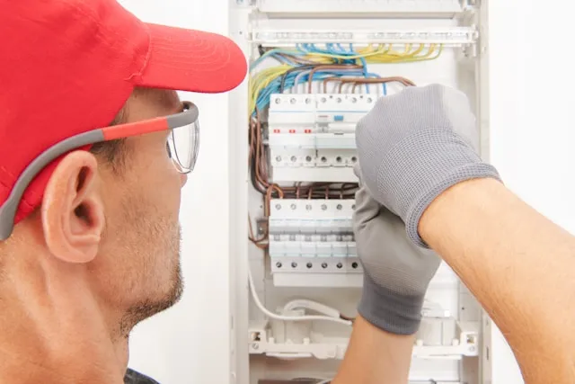 Electrician upgrading outdated electrical panel in a Montreal home